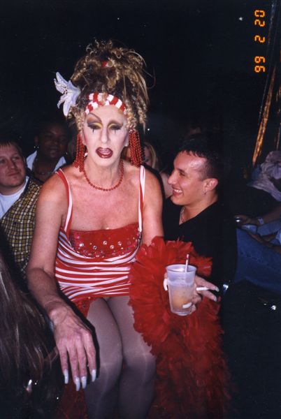 Miss P wearing a red and white outfit and sitting on top of a customer during a performance in Footlight Theatre at Parliament House, Orlando.

For all other purposes please email: floridalgbtqmuseum@gmail.com