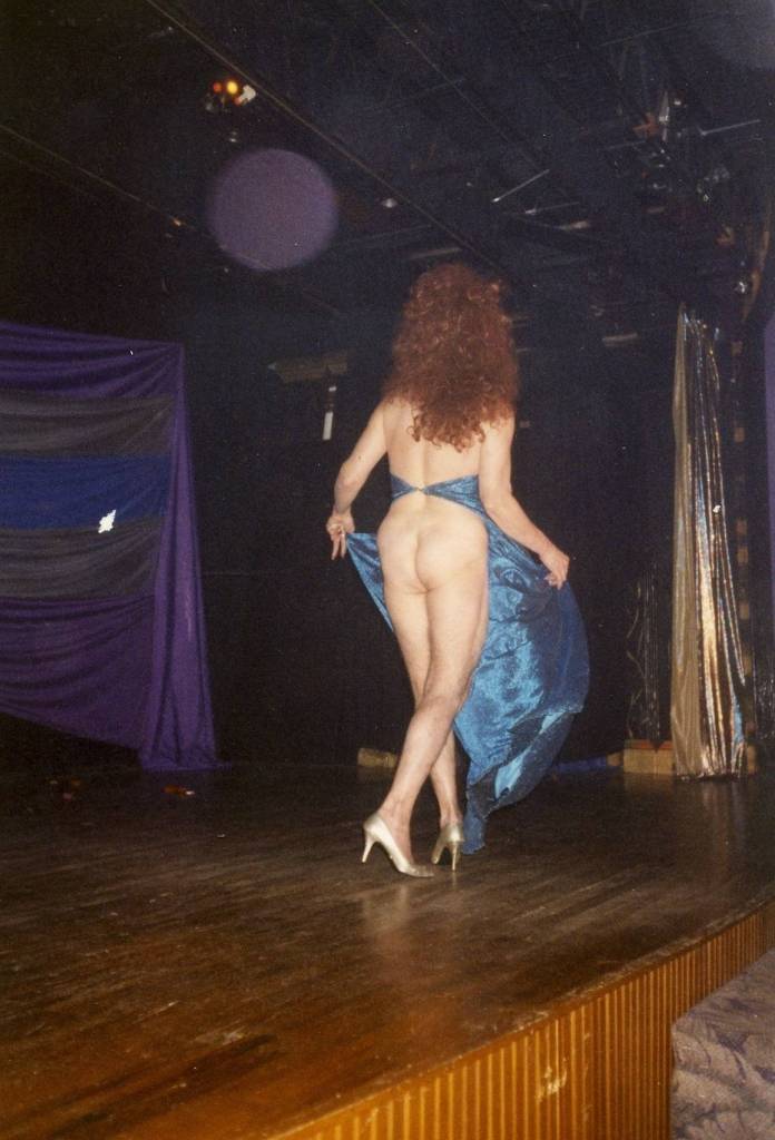 Miss P of performing "Love with all the Trimmings" by Barbara Streisand on Footlight Theatre at Parliament House, Orlando. Miss P is showing backside. Loc Robertson comments that the first part of the number would be all serious and her just standing there, then she would turn around and reveal that there was no back to her dress, spinning around so that you can see 'everything'. One of her iconic numbers.

Images may be used for educational purposes only.
Image credit: Image courtesy of LGBTQ History Museum of Central Florida.
For all other purposes please email: floridalgbtqmuseum@gmail.com