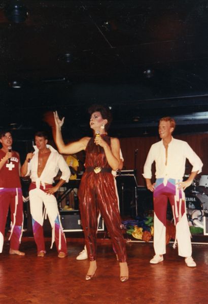  Miss P performing on a cruise the Gay Community Center arranged titled P on the Sea. Left to right: David Lee, Philip Johnson, Miss P, and Doug Bowser. Image from Paul Wegman's collection.

Images may be used for educational purposes only.
Image credit: Image courtesy of LGBTQ History Museum of Central Florida.
For all other purposes please email: floridalgbtqmuseum@gmail.com